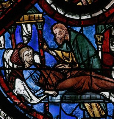 LE Samaritain se penche sur le blessé