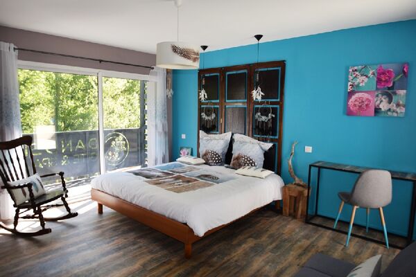 Chambre Plumes avec lit électrique 2x90 canapé rocking chair balcon et terrasse avec vue rivière et jacuzzi extérieur